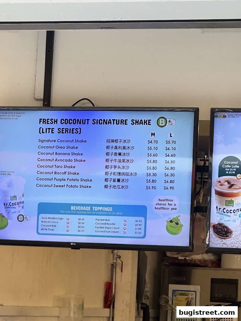 A digital menu displaying fresh coconut signature shakes and beverage toppings with prices.