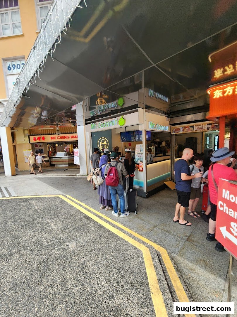 People queuing outside Mr. Coconut Bugis Street, a popular beverage shop.