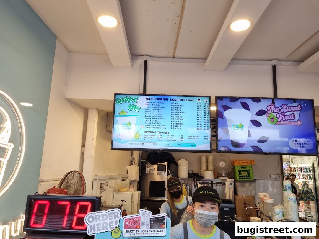 A menu board displaying fresh coconut shakes and beverage toppings at Mr. Coconut.