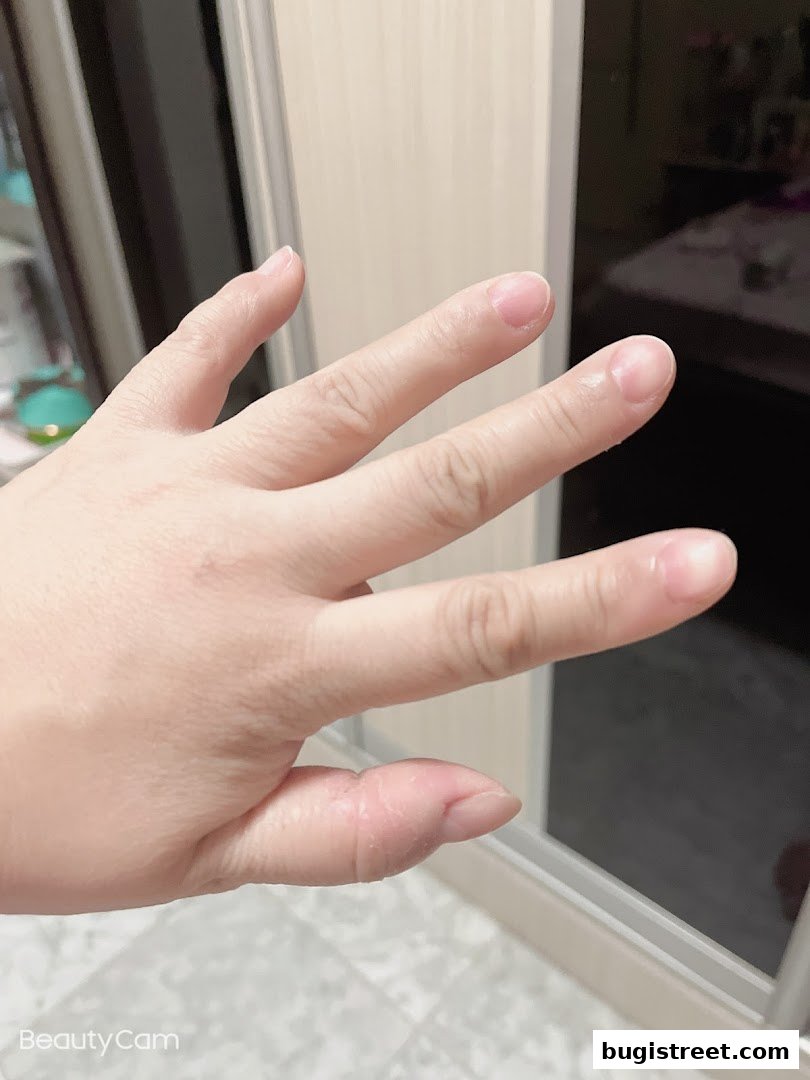 A close-up shot of a hand with natural, unpolished nails.