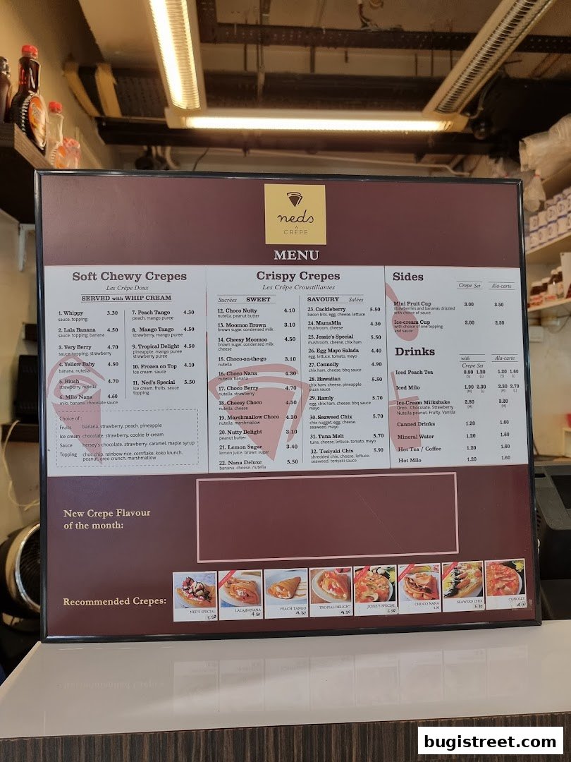 A menu board for Neds Crepes & Coffee, displaying various crepe options and drinks.