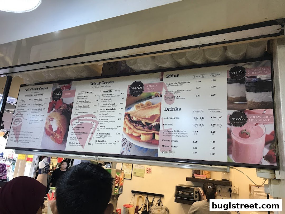 A menu board displaying various crepes, sides, and drinks with prices.
