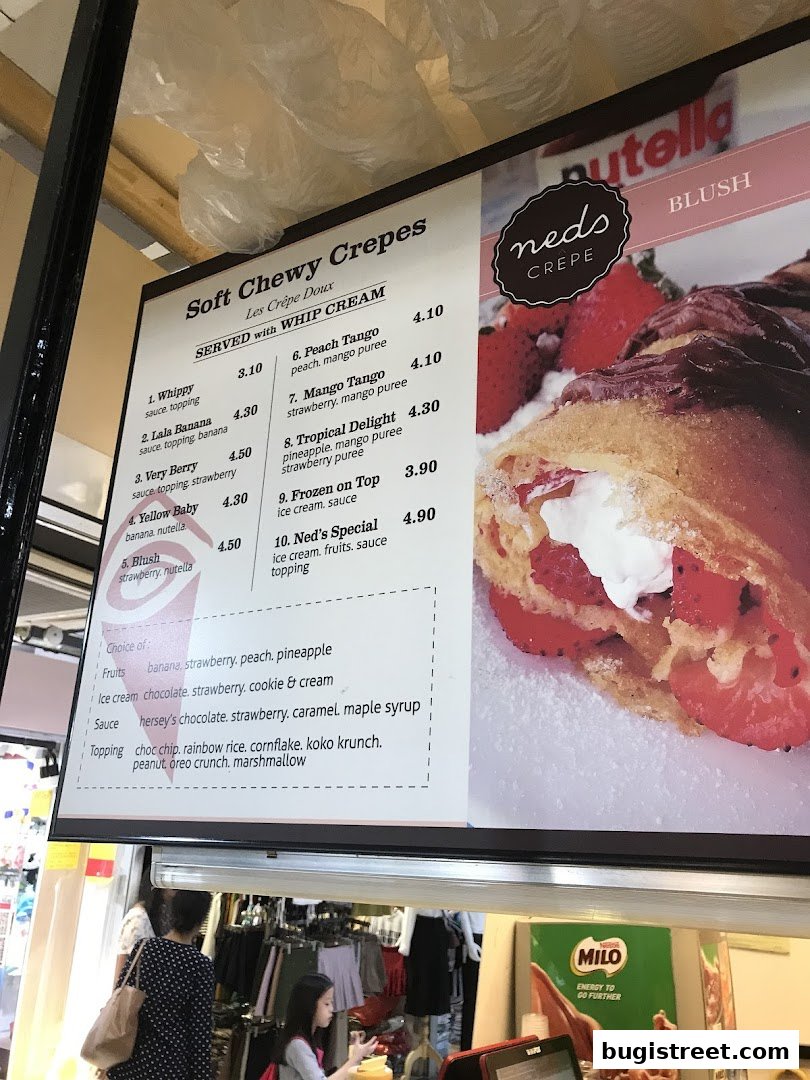 A menu board for Neds Crepes & Coffee, showcasing various crepe options and ingredients.