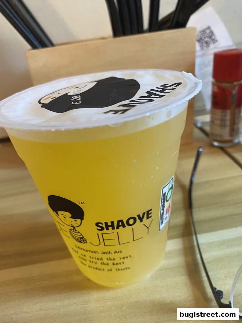 A close-up of a yellow jelly drink with the brand name 'Shaove Jelly' visible.