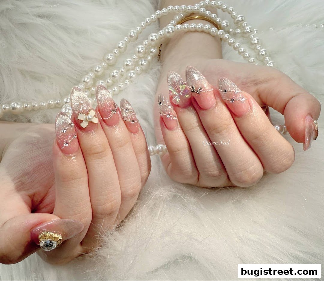 Close-up of hands with elaborate, sparkling nail art and pearl necklaces.