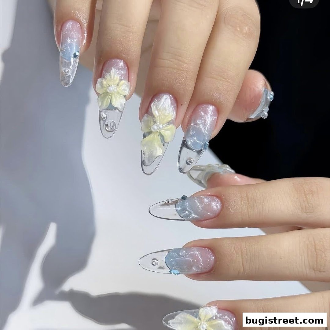 Close-up of hands with intricate floral and gem-embellished nail art.