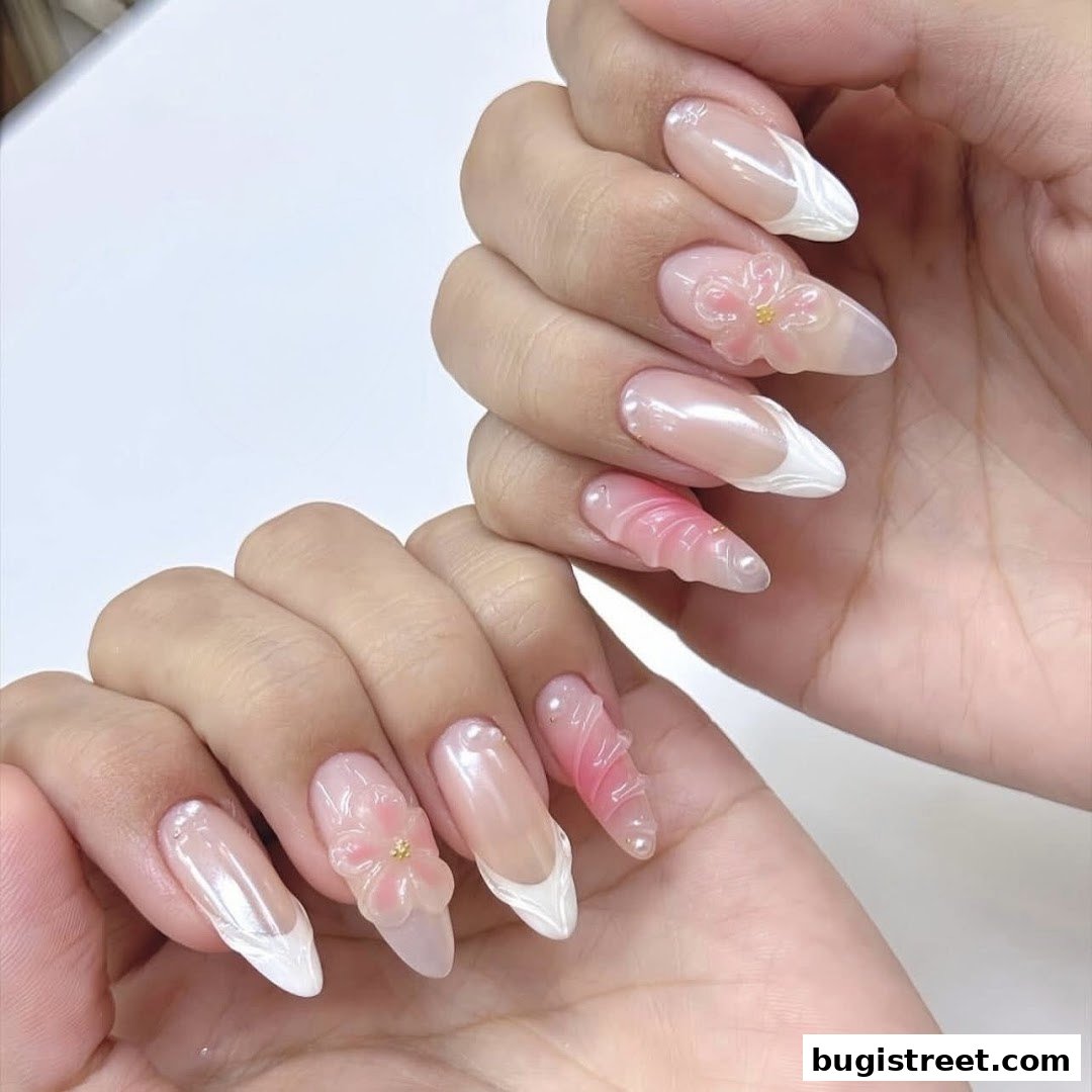Close-up of hands with intricate, artistic nail designs featuring flowers and 3D elements.