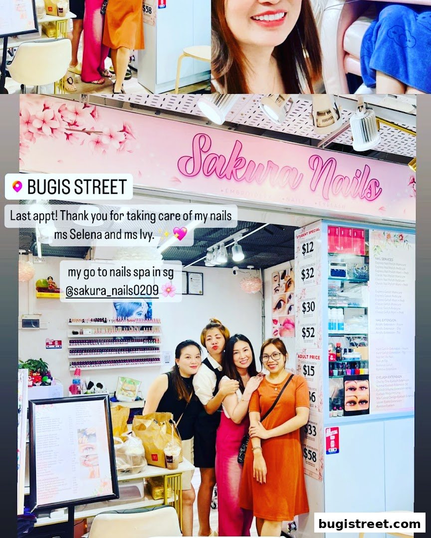 A group of women posing for a photo inside Sakura Nails, a nail salon.