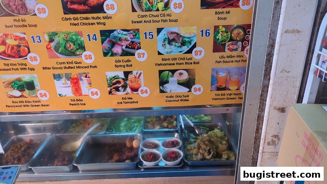 A colorful menu board displaying various Vietnamese dishes and drinks with prices.