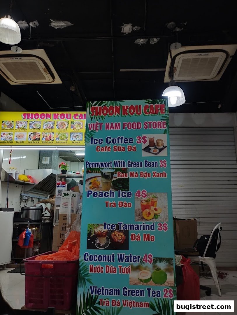 A menu board for Shoon Kou Cafe, featuring Vietnamese food and drinks with prices.