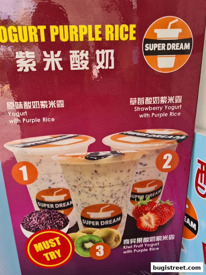 A menu display for Super Dream yogurt drinks featuring purple rice and fruit flavors.