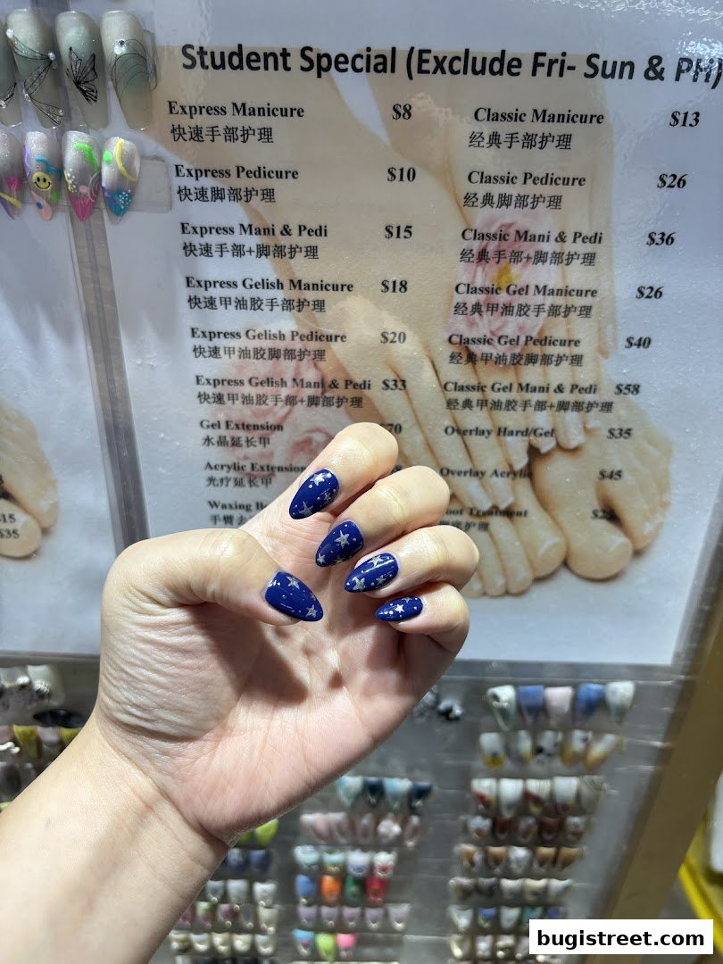 A hand with starry blue nails is shown in front of a nail service menu.