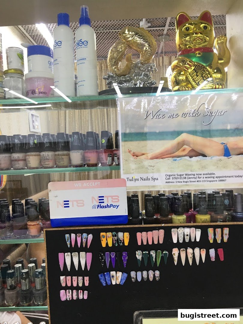 A display of nail polish bottles, artificial nails, and spa products at Tulips Nails Spa.