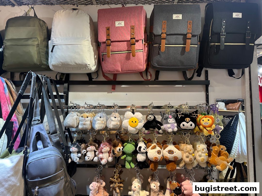 A display of backpacks and plush keychains in various colors and designs.